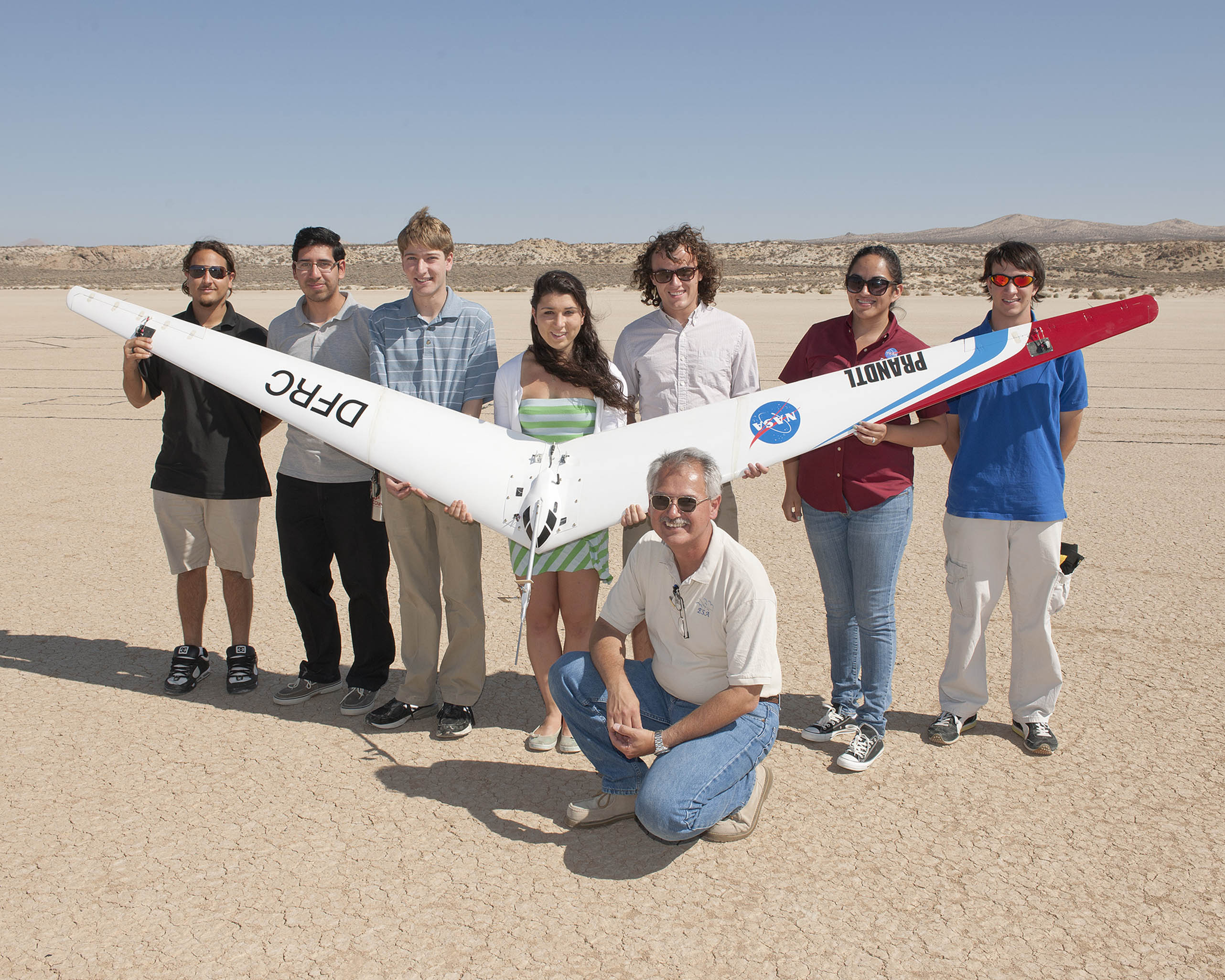 NASA Dryden's Al Bowers and some of the students he mentored in the 2013 NASA Aeronautics Academy display the second subscale Prandtl-D flying wing following its first test flight last August. (NASA / Tom Tschida)